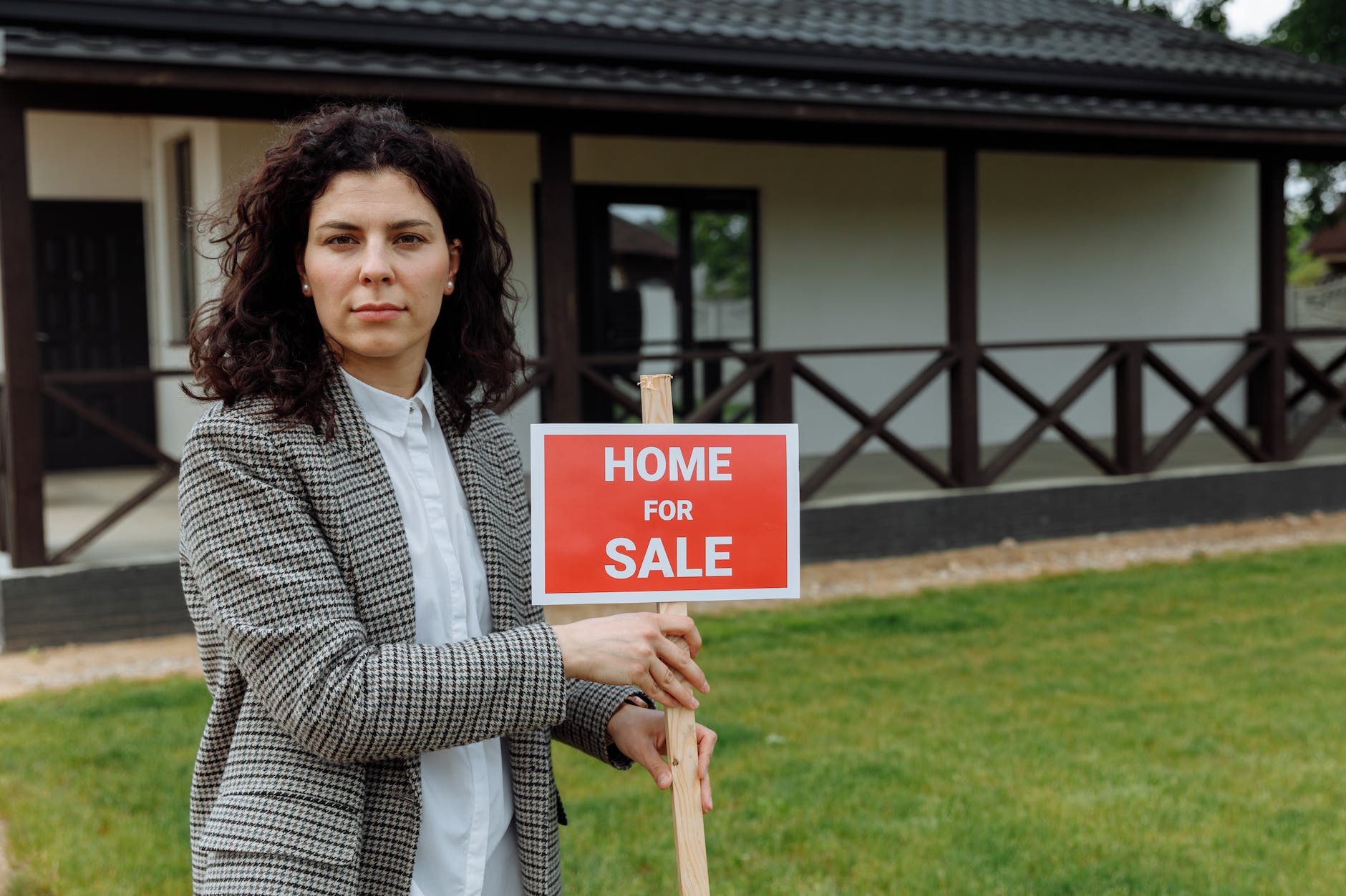 a real estate agent holding a sign